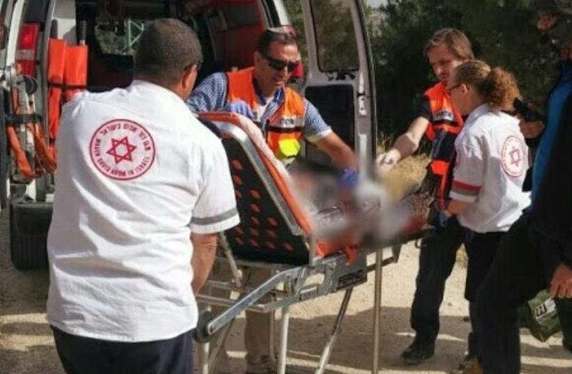 MDA paramedics treat victim at scene of suspected terror stabbing in Jerusalem's Armon Hanatziv (photo credit: MDA)