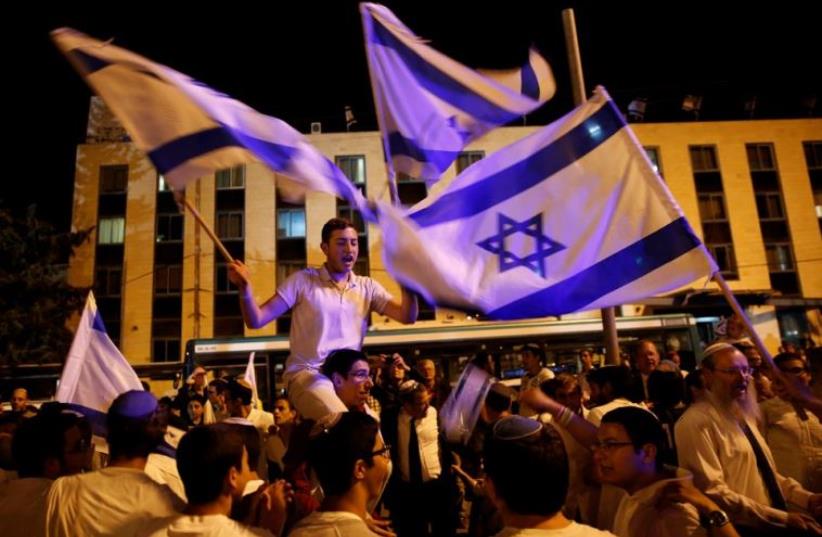 Israelis dance with Israeli national flags during celebrations marking Israel's 68th Independence Day in Jerusalem (photo credit: REUTERS)
