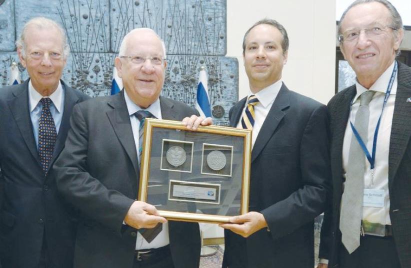 PRESIDENT REUVEN RIVLIN stands with members of an Israel Bonds delegation (photo credit: MARK NEYMAN / GPO)