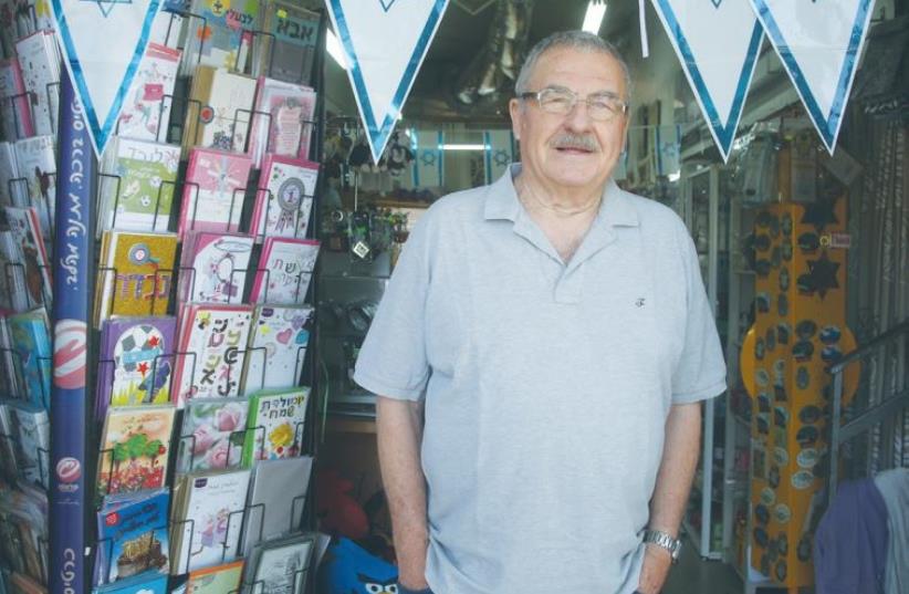 SHMUEL SHERF stands in the entrance to his family-owned toy store in Katzrin. (photo credit: MARC ISRAEL SELLEM)