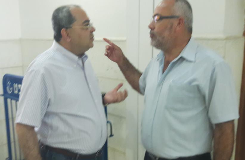 MK AHMAD TIBI (left) speaks with MK Osama Sa’adi at Ben Deri’s trial yesterday (photo credit: YONAH JEREMY BOB)