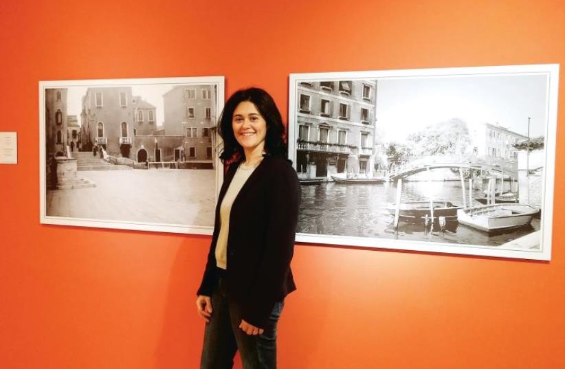 Curator Micol Schreiber Benarroch with a photograph of her grandmother’s house in Venice (photo credit: Courtesy)