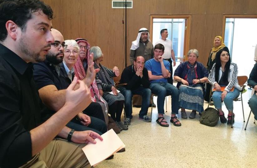 An interfaith group led by Ra’anan Mallek learns together before prayer begins (photo credit: ARIEL DOMINIQUE HENDELMAN)