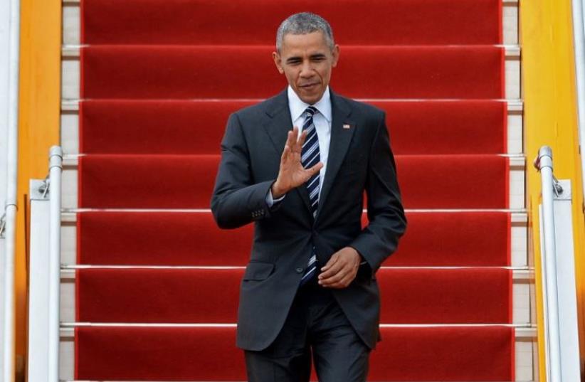 US President Barack Obama waves as he arrives at the Tan Son Nhat airport in Ho Chi Minh City (photo credit: AFP PHOTO)