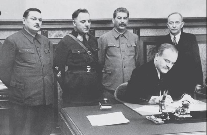 The Soviet leadership with (standing at left) Central Committee secretary Andrei Zhdanov. (Leader Joseph Stalin is standing second from right.) (photo credit: Wikimedia Commons)