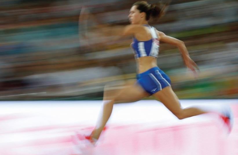 Hanna Knyazyeva-Minenko wins a silver medal in the women’s triple jump at World Championships in Beijing, August 24, 2015 (photo credit: REUTERS)