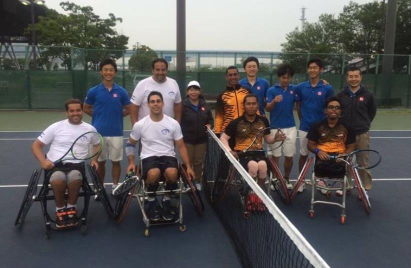 Israel's wheelchair tennis team (left) pictured above with their Malaysians counterpart ahead of their meeting in the World Team Cup wheelchair tennis event at the Ariake Colosseum in Tokyo earlier this week. Israel was scheduled to face Moroccans yesterday, but they never showed. (photo credit: ISRAEL TENNIS ASSOCIATION)