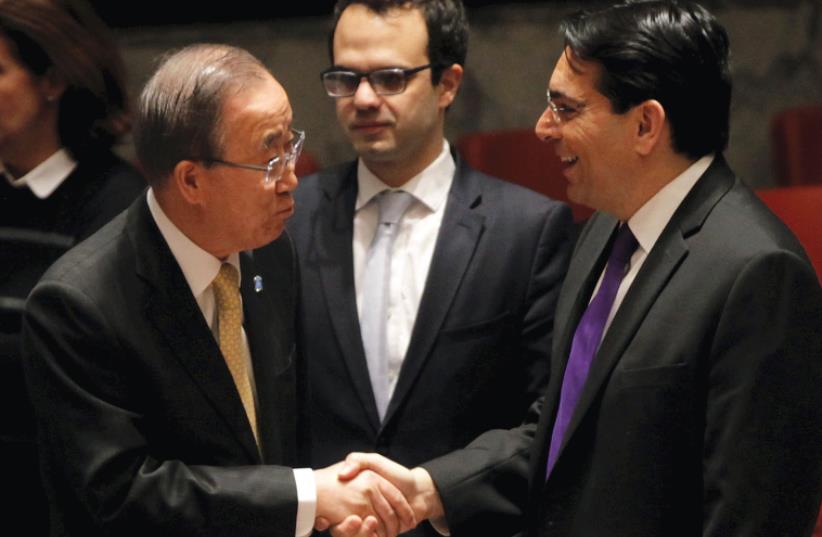 UN SECRETARY-GENERAL Ban Ki-moon welcomes Israel’s Ambassador Danny Danon before a Security Council meeting on the Middle East in January. (photo credit: MIKE SEGAR / REUTERS)