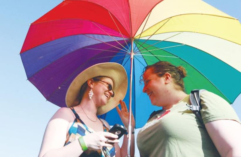 A COUPLE ENJOYS last year’s Gay Pride Parade in Jerusalem.  (photo credit: MARC ISRAEL SELLEM)