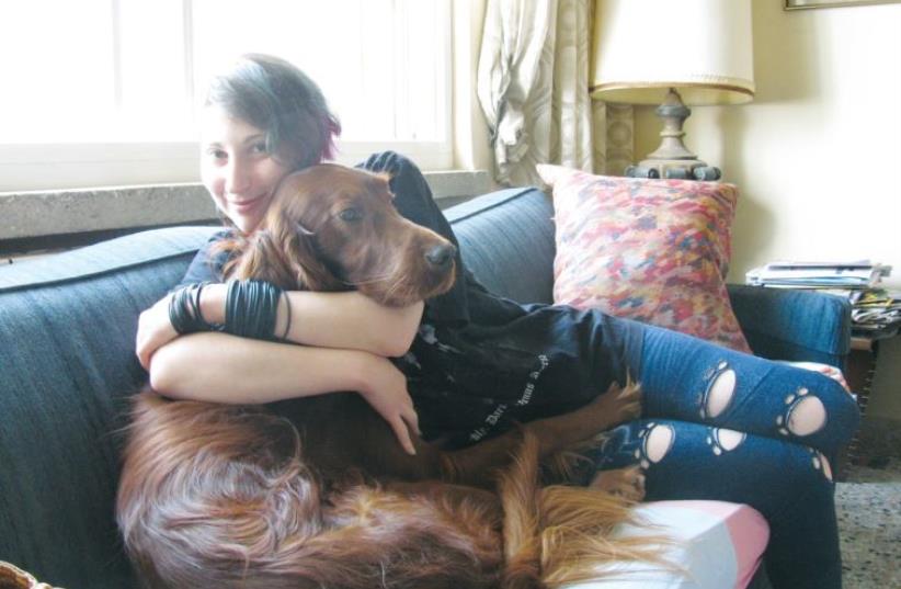Shaked Gorodescher, 22, with her dog Riley. (photo credit: ANAV SILVERMAN)