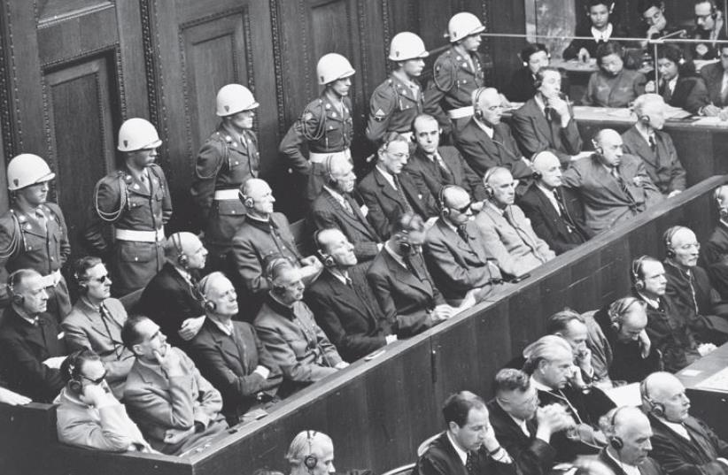 Nazi defendants listen to testimony at the Nuremberg trials, which set a precedent for prosecuting crimes against humanity (photo credit: US HOLOCAUST MEMORIAL MUSEUM)