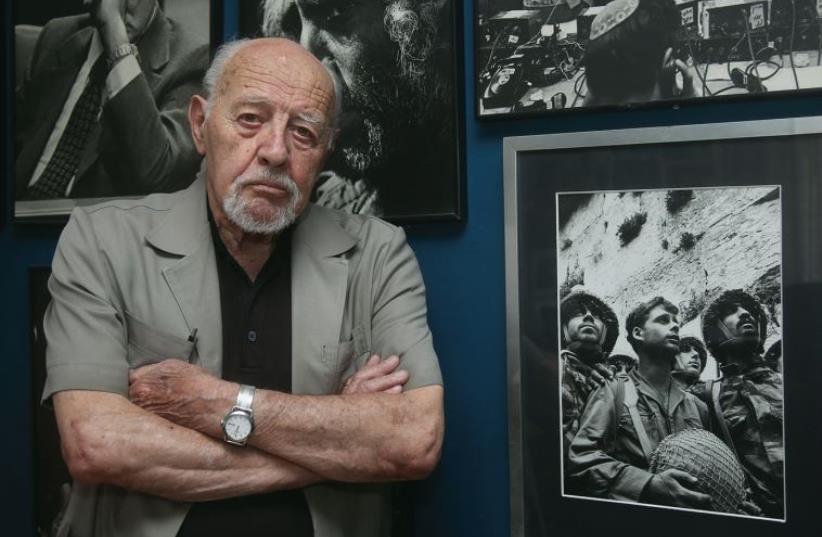 David Rubinger at home, flanked by some of his most iconic photos – including, of course, the June 7, 1967, shot of the three paratroopers at the newly liberated Western Wall (photo credit: MARC ISRAEL SELLEM)
