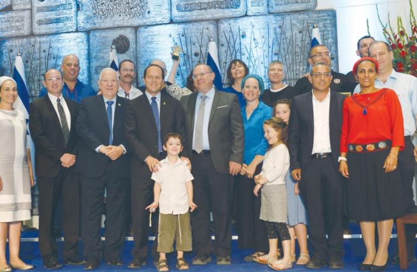 PRESIDENT REUVEN RIVLIN and Jerusalem Mayor Nir Barkat (third and fourth from left) pose with winners of the second annual Jerusalem Unity Prize awards at the President’s Residence last night. (photo credit: GPO)