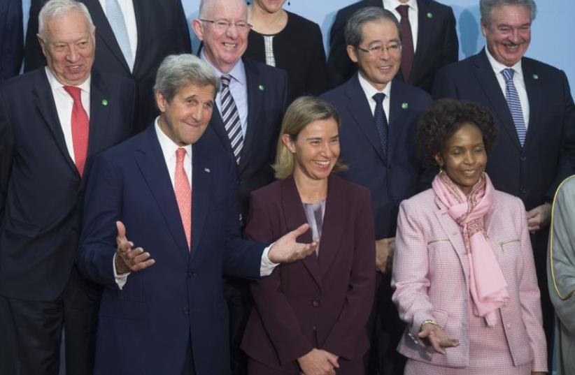 US Secretary of State John Kerry (L), European Union High Representative for Foreign Affairs Federica Mogherini (C) and South African Foreign Minister Maite Nkoana-Mashabane (R) arrive for a family photo during an international and interministerial meeting in a bid to revive the Israeli-Palestinian  (photo credit: SAUL LOEB / AFP)