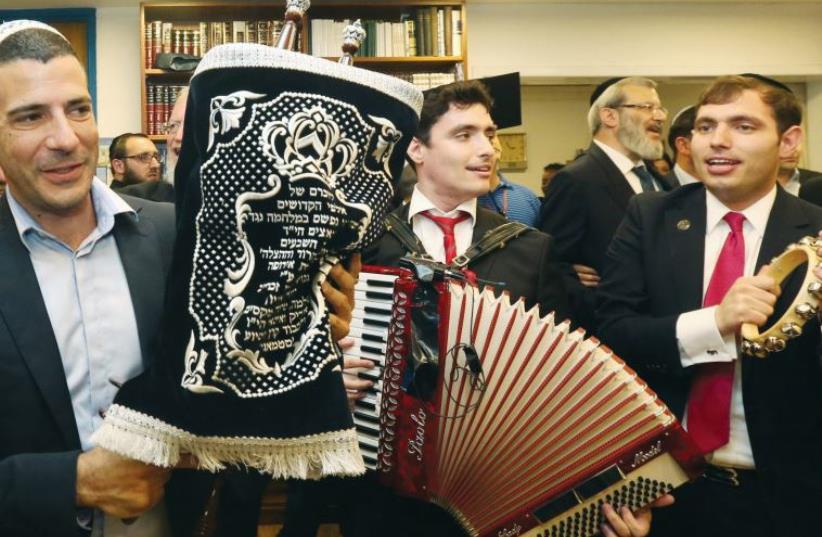 Men celebrate at the dedication of a new Torah scroll in the Knesset in 2014 (photo credit: MARC ISRAEL SELLEM)