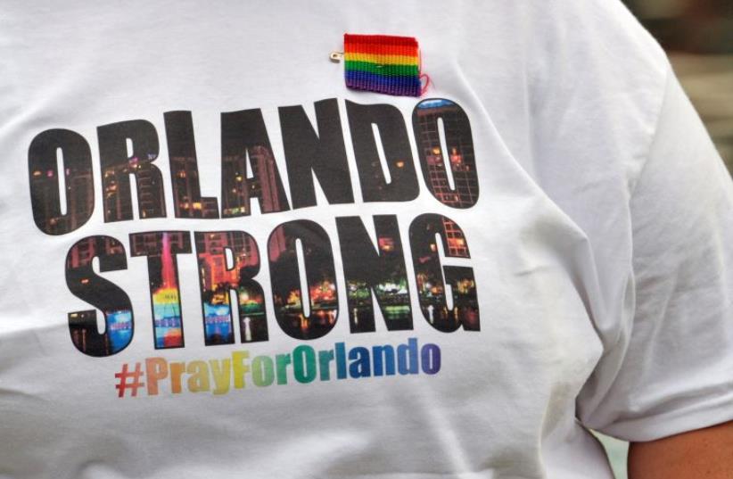 A resident wears an "Orlando Strong" T-shirt during a vigil at Lake Eola Park in Orlando. (photo credit: STEVE NESIUS/REUTERS)