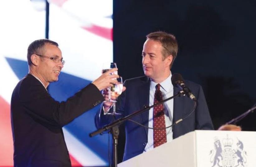 TOURISM MINISTER Yariv Levin (left) and British Ambassador David Quarrey toast the queen of England on her 90th birthday. (photo credit: NIMRAUD SAUNDERS)