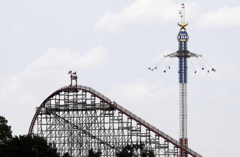 The Texas Giant roller coaster ride (L) is seen at the Six Flags Over Texas amusement park in Arlington, Texas (photo credit: REUTERS)