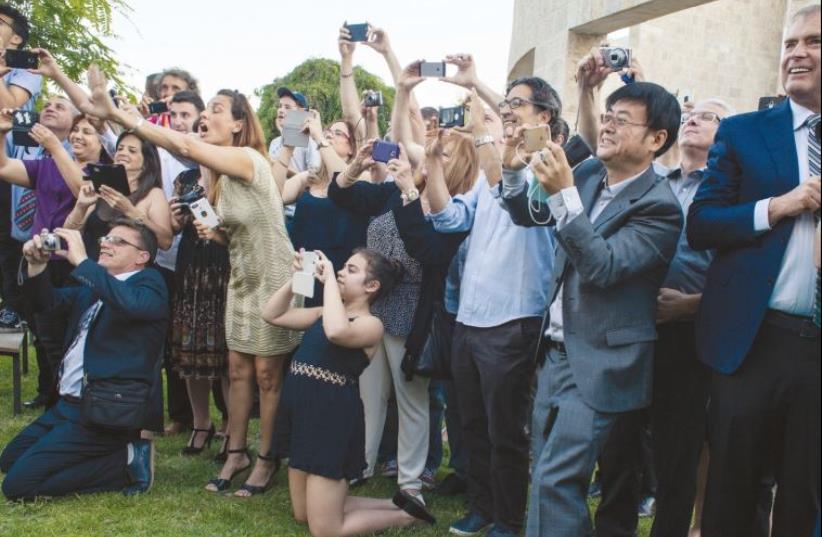 Excited parents snap photos of graduates of the Eastern Mediteranean International School (photo credit: ANNA LOSHKIN)