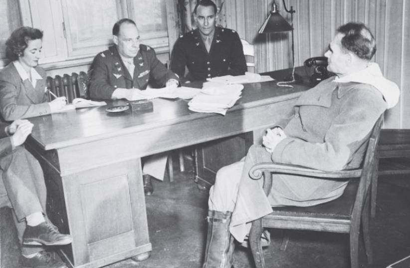 Rudolf hess speaks to a lawyer at the Nuremberg trials (photo credit: Wikimedia Commons)
