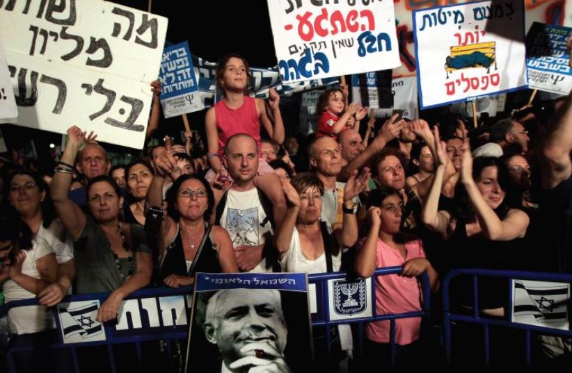 ISRAELIS DEMONSTRATE in Tel Aviv in September 2011 calling for social justice and lower living costs (photo credit: REUTERS)
