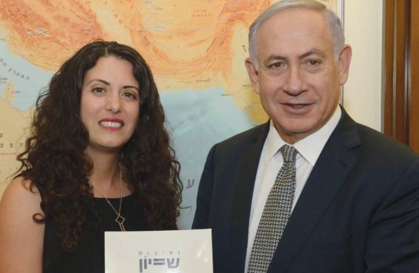 EQUAL EMPLOYMENT Opportunities Commissioner Mariam Kabaha submits the commission’s 2015 report to Prime Minister Benjamin Netanyahu yesterday. (photo credit: GPO)