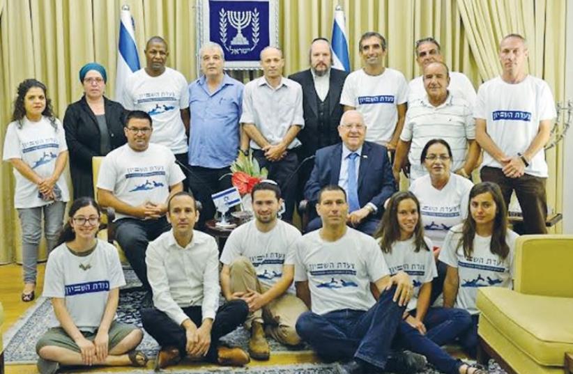 PRESIDENT REUVEN RIVLIN and Yeroham Mayor Michael Biton (middle row, left) pose with participants of the ‘equality march’ in the President’s Residence in Jerusalem yesterday. (photo credit: HAIM ZACH/GPO)