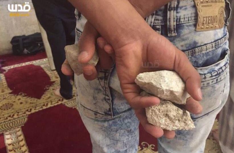Palestinians who barricaded themselves in the al-Aksa Mosque hurl stones at Israeli security forces, June 27, 2016‏ (photo credit: PALESTINIAN MEDIA)
