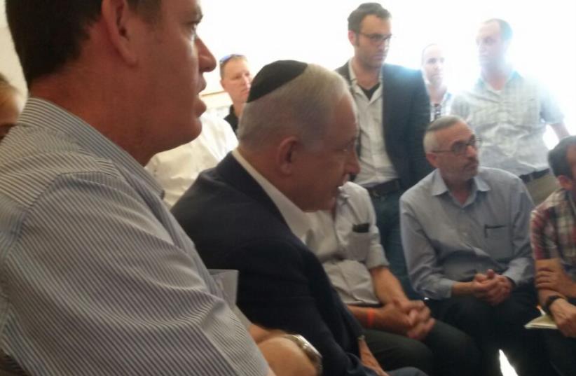 PM Netanyahu at family home of slain teenage terror victim in Kyriat Arba (photo credit: COURTESY/HAVERIM LE'SHAAT TZARA)
