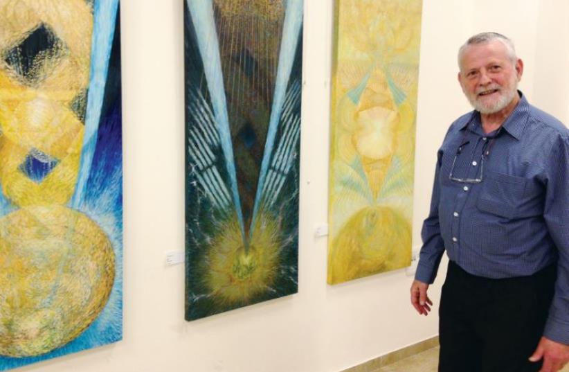 Roy Karp alongside his paintings (photo credit: JACK BROOK)