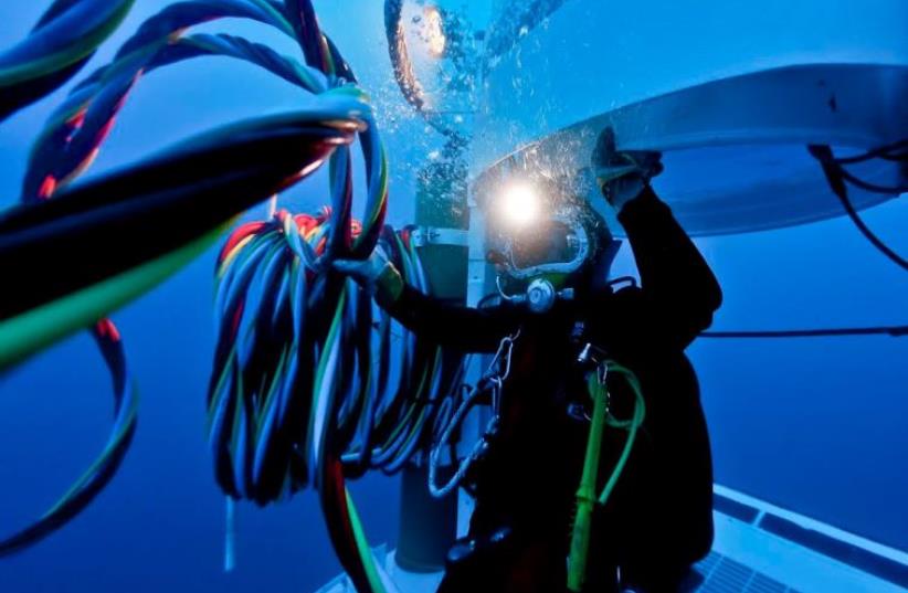  A DIVER FROM the Israel Navy’s Unit for Underwater Missions works with a welding torch in the sea depths (photo credit: IDF)