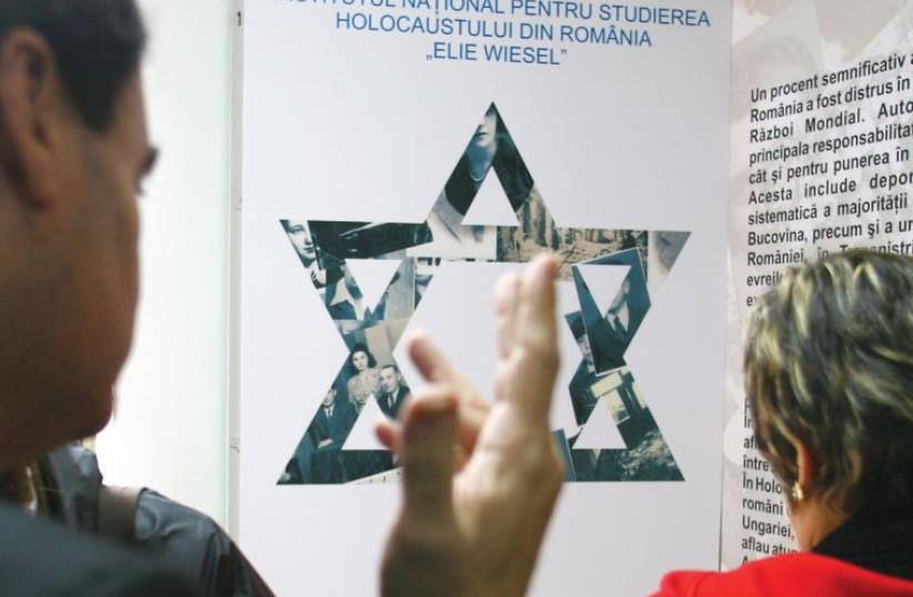 ROMANIAN JEWS visit an exhibition about the Holocaust in Romania at the Elie Wiesel Institute for Holocaust Studies during the annual Holocaust Remembrance Day in Bucharest in 2006. (photo credit: REUTERS)