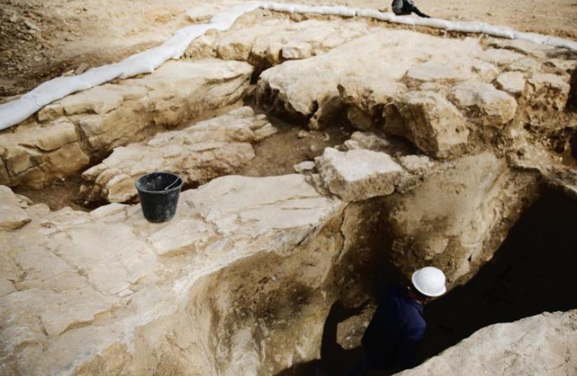 An Antiquities Authority employee works inside a ritual bath, part of a find exposed in Jerusalem this past March (photo credit: REUTERS)
