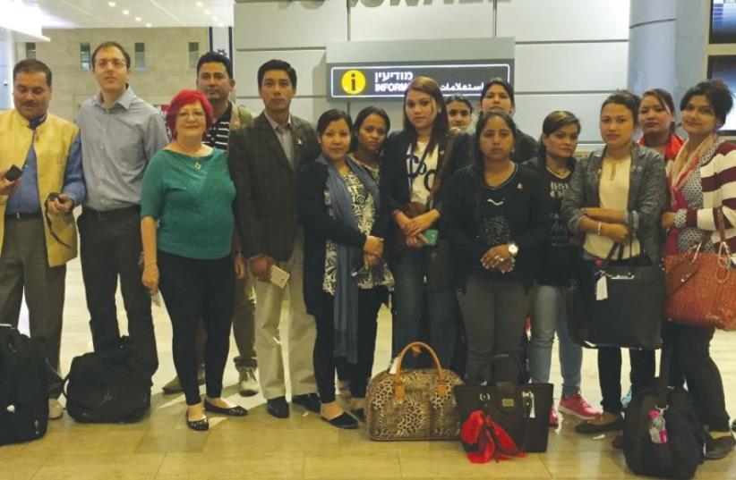 NEPALESE CAREGIVERS pose upon arrival at Ben-Gurion Airport recently. (photo credit: CENTER FOR INTERNATIONAL MIGRATION AND INTEGRATION)