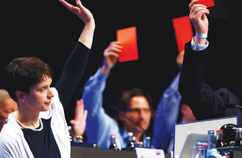 FRAUKE PETRY (left), chairwoman of the anti-immigration party Alternative for Germany, votes during the second day of the party’s congress in Stuttgart in May. (photo credit: WOLFGANG RATTAY / REUTERS)