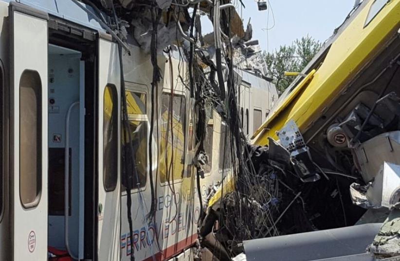 Two passenger trains are seen after a collision in the middle of an olive grove in the southern village of Corato, near Bari, Italy, in this handout picture released by Italian Firefighters July 12, 2016 (photo credit: REUTERS)
