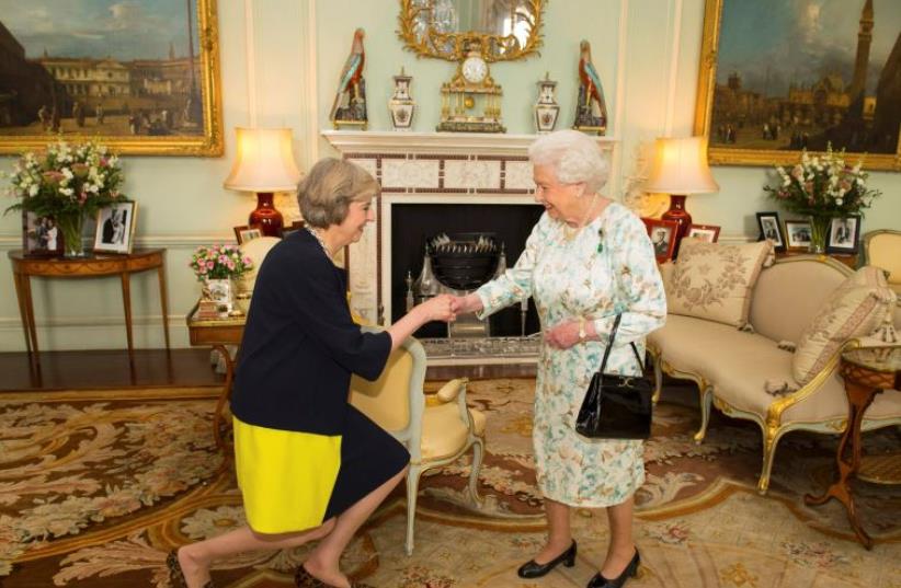 Britain's Queen Elizabeth welcomes Theresa May at the start of an audience in Buckingham Palace, where she invited her to become Prime Minister, in London July 13, 2016.  (photo credit: REUTERS)
