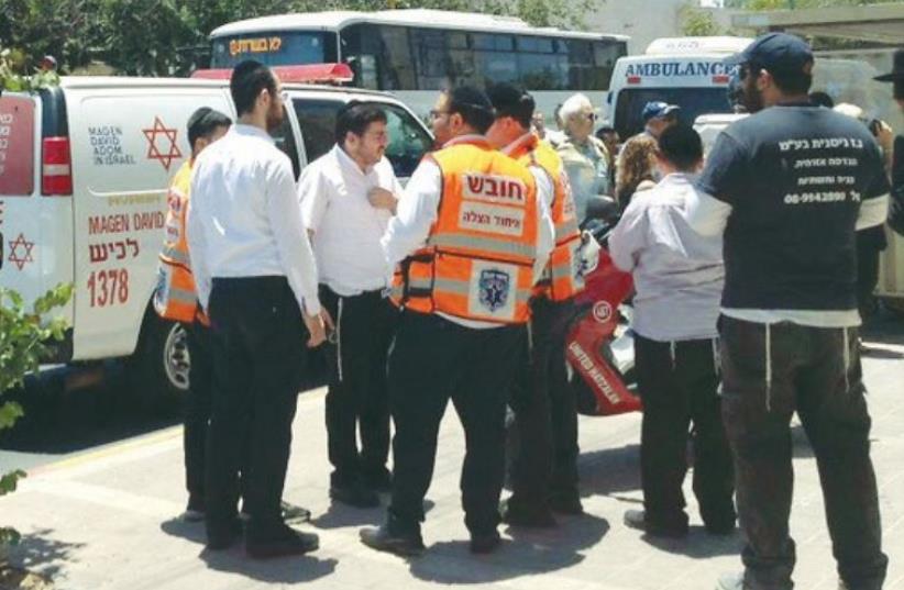 AMBULANCE STAFF in Ashdod attend the scene on May 30 where an infant left in a car died. (photo credit: UNITED HATZALAH‏)