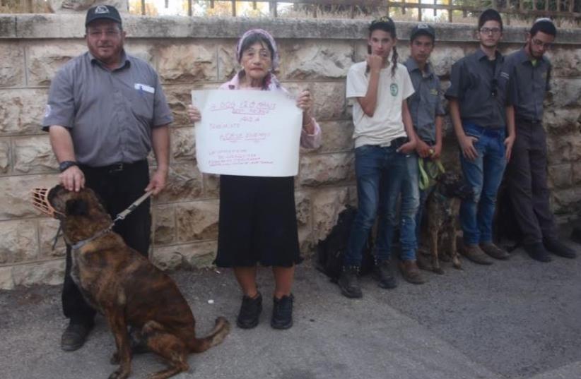  Mike Ben Yaakov, commander of the Israeli Dog Unit (left) stands next to Shifra Hoffman, founder of Victims Against Arab Terror International at a protest in front of the Prime Minister’s Residence in Jerusalem on Thursday evening. (photo credit: MARC ISRAEL SELLEM)