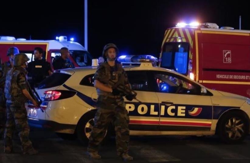 French soldiers and rescue forces are seen at the scene whare at least 30 people were killed in Nice, France, when a truck ran into a crowd celebrating the Bastille Day national holiday July 14, 2016.  (photo credit: REUTERS/ERIC GAILLARD)