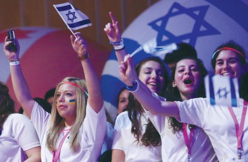 Birthright participants wave flags and cheer during a recent event in Jerusalem. (photo credit: MARC ISRAEL SELLEM/THE JERUSALEM POST)