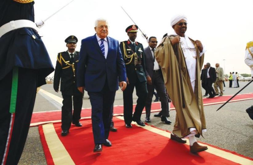 SUDANESE PRESIDENT Omer Hassan al-Bashir welcomes PA President Mahmoud Abbas at Khartoum Airport on Tuesday. (photo credit: REUTERS)