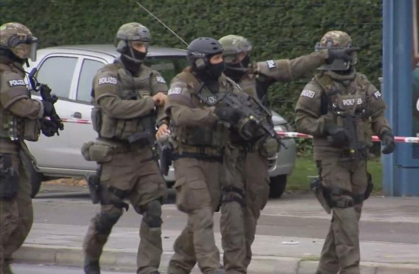 A screen grab taken from video footage shows special forces police officers walking along a street outside the Olympia shopping mall following a shooting rampage in Munich, Germany July 22, 2016 (photo credit: REUTERS)