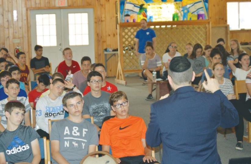FORMER MK Dov Lipman speaks to youngsters at Camp Mesorah in Guilford, New York on Thursday (photo credit: Courtesy)