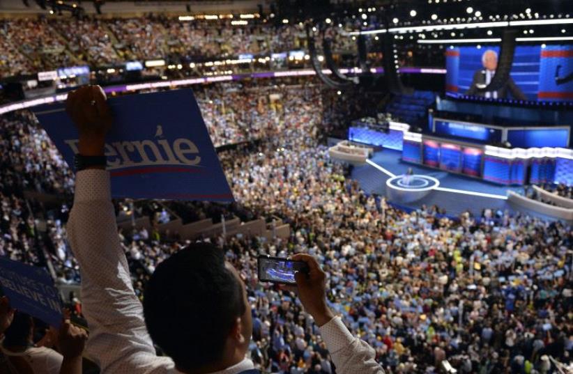 A delegate holds a Bernie Sanders sign during the Democratic National Convention in Philadelphia, Pennsylvania, US July 25, 2016 (photo credit: REUTERS)