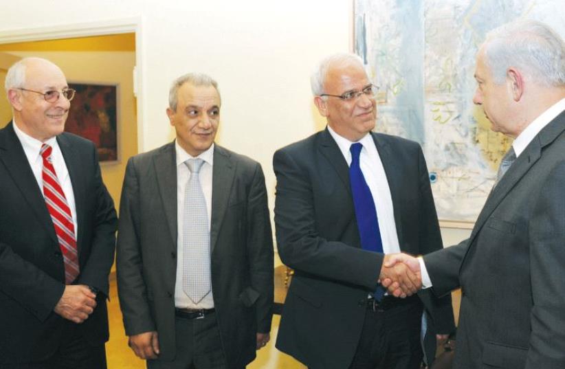 Netanyahu shakes hands with member of the Palestinian Parliament Dr. Saeb Erekat in Jerusalem in April 2012. On the far left side, is Attorney Yitzhak Molcho (photo credit: GPO)