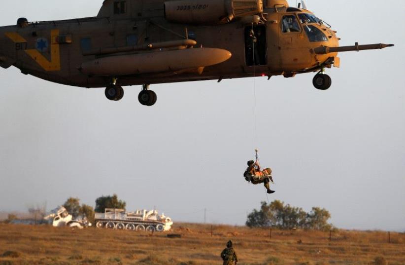 An IAF Sikorsky CH-53 helicopter demonstrates the evacuation of a wounded person during an aerial demonstration at a graduation ceremony in southern Israel [File June 30, 2016] (photo credit: REUTERS)