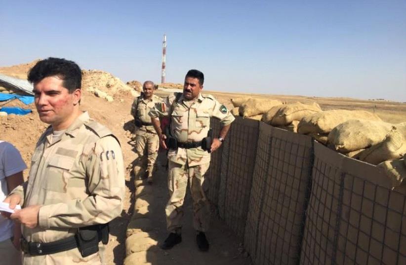 Kurdish peshmerga stand at a sandbag position 17km east of Mosul overlooking Bashiqa. (photo credit: SETH J. FRANTZMAN)