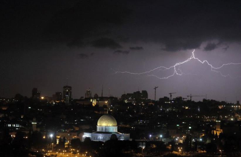 Lightning illuminates the sky over the Dome of the Rock in Jerusalem (photo credit: AMMAR AWAD/REUTERS)