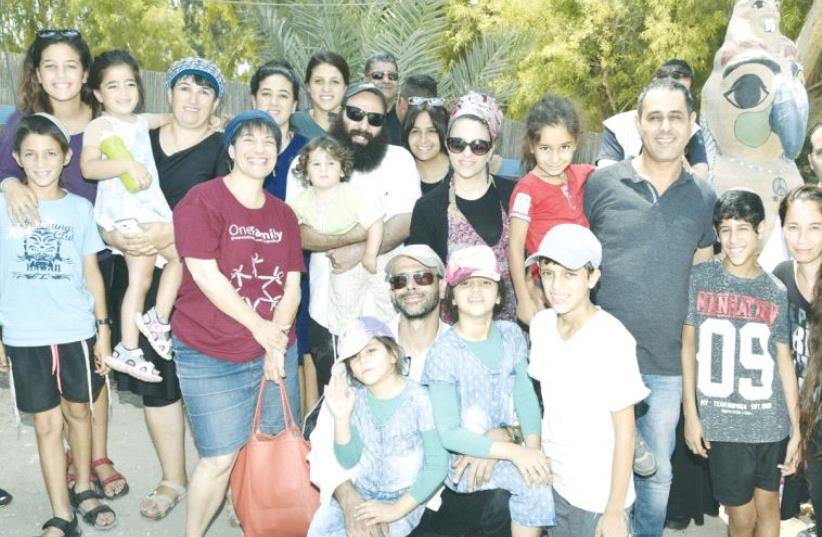 A GROUP OF terrorism victims and their families pose for a photo at a three-day retreat this week in Tiberias organized for them by the NGO OneFamily. (photo credit: SARAH LEVIN/ONEFAMILY)